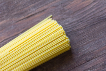 spaghetti, Italian pasta for cooking lie on a wooden background