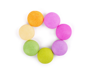 Multicolored round candies on a white background