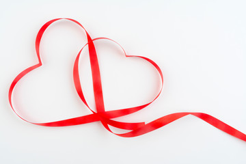 Greeting card for Valentine's day. Heart from red ribbon on a white background. Romantic Love Concept.