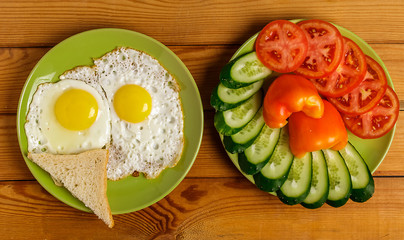 Fried eggs and pieces of vegetables on the table.