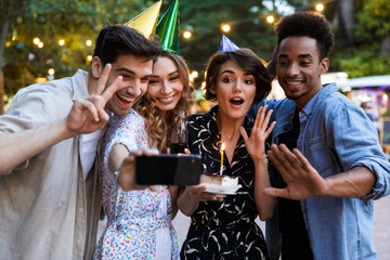 Group of happy multhiethnic friends celebrating