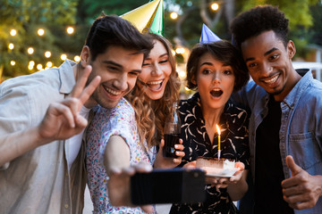 Group of excited multhiethnic friends