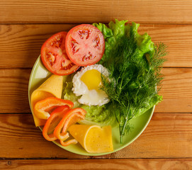 Fried eggs and pieces of vegetables on the table.