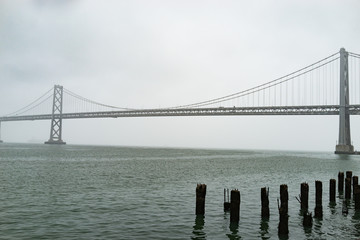 Foggy Bay bridge over river San Francisco
