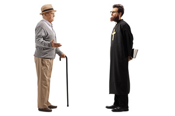 Senior man with cane talking to a priest