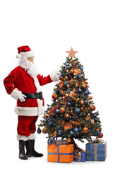 Santa Claus decorating a Christmas tree