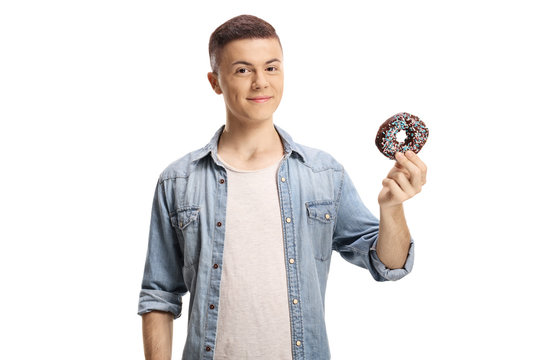 Young man holding a chocolate donut