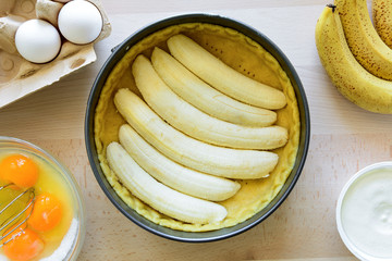 Preparation banana cake (cheesecake) making from ingredients on wooden table background. Flat lay. Top view.