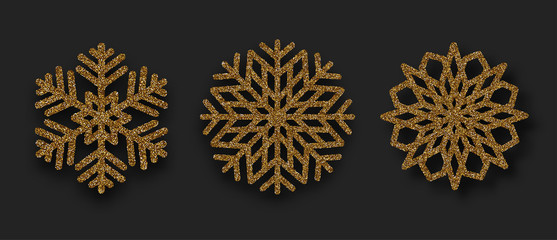 Set of beautiful shiny golden snowflakes isolated on black background.