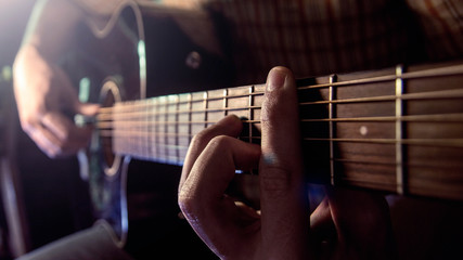 Fototapeta na wymiar Guitar Playing. Man Playing Acoustic Guitar Closeup