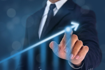 business man point hand on the top of arrow graph with high rate of growth. The success and growing...
