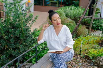Portrait of a beautiful woman writing in a book are sitting thinking about the job at the...