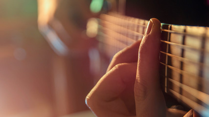 Fototapeta premium Play the guitar, man is playing the guitar, close up