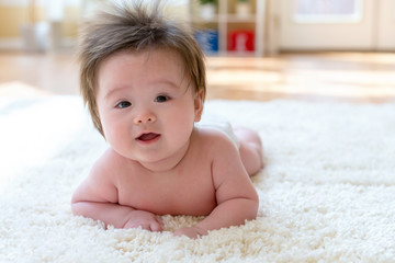 Happy baby boy lying down and resting