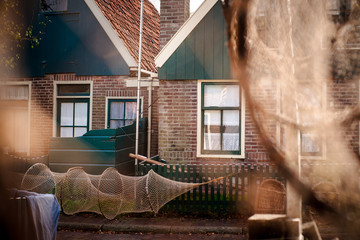 closeup of old fishing nets, wooden rounded sinkers and weathered rope in a glimpse of sunlight