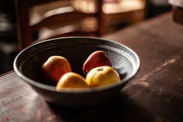 Autumn background. Ripe apples on old wooden background with old scales and natural light.