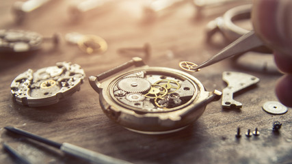 Watchmaker is repairing the mechanical watches in his workshop