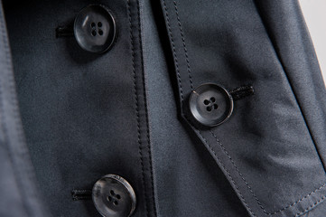 Partial close-up of buttons in dark clothes
