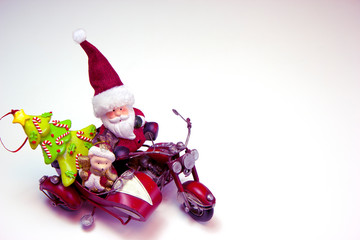 Santa Claus and polar bear on the red motorcycle are going to the Christmas party. Side view. Christmas and New Year holiday background concept. Copy space for text.