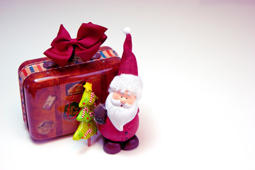 Santa Claus is going to travel with a huge suitcase. Christmas and New Year holiday background concept. Copy space for text.