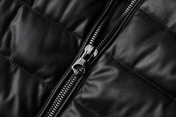 Black leather texture closeup as background. Jacket leather fabric texture.