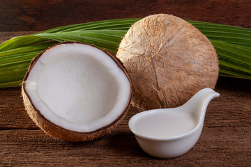 Coconut and coconut milk on wooden background.