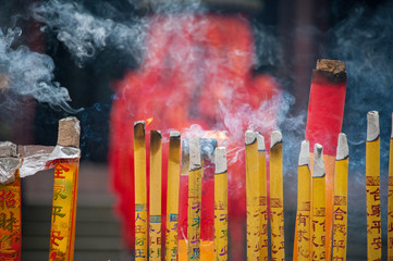 Incense candles burn in temple coutyard