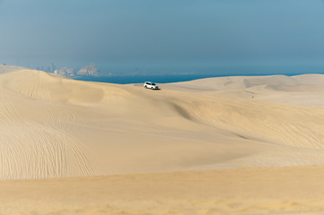 Fototapeta na wymiar Car in sand dunes