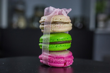 Three macaroon multicolored macaroon tied with an organza ribbon, French dessert