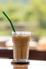 Iced chocolate on outdoor wood desk background