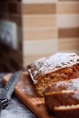 Homemade traditional sweet  cherry pie sprinkled with sugar powder. Cut cake