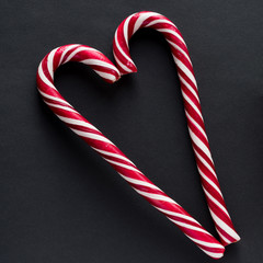Traditional  candy cane on black background. New Year and Christmas concept