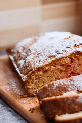 Homemade traditional sweet  cherry pie sprinkled with sugar powder. Cut cake
