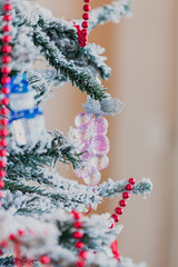 Beautiful toys weigh on branch of New Year tree