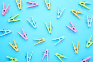 Plastic clothes pins on a blue background