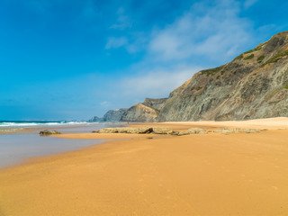 Fototapeta na wymiar Summer Ocean Beach And Mountains Landscape In Portugal
