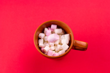 top view cup with marshmallows red background