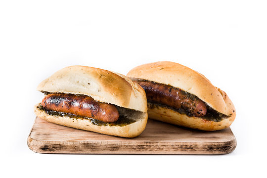 Choripan. Traditional Argentina sandwich with chorizo and chimichurri sauce. isolated on white background