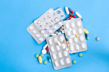 Various medications, medicine and tablets, blue background