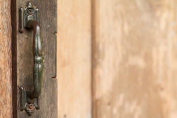 Metal old rusty handle on wooden door