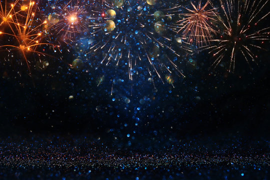 abstract gold, black and blue glitter background with fireworks. christmas eve, 4th of july holiday concept.