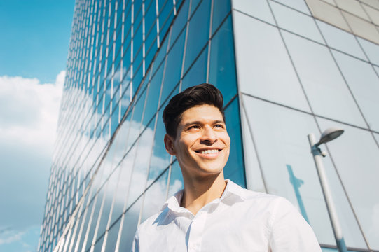 Smiling young man standing outdoors
