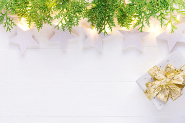 Beautiful elegant Christmas New Year background. White stars sparkling golden lights garland green...