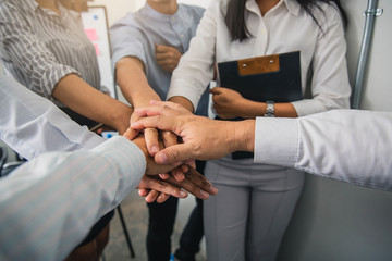 Obraz premium People with their hands together. Business team work concept.Friends with stack of hands showing unity and teamwork.