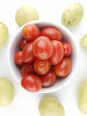 Cherry tomatoes and potato on white background