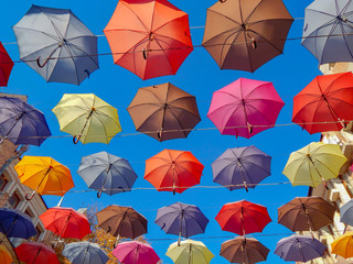 colorful umbrellas soaring hanging in the blue sky