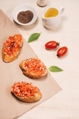 Simple italian appetizing bruschetta with tomato, on wooden table