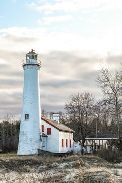 Remote Michigan Lighthouse Beach Landscape. Sturgeon Point Lighthouse on the shores of Lake Huron in the Lower Peninsula of Michigan in vertical orientation.