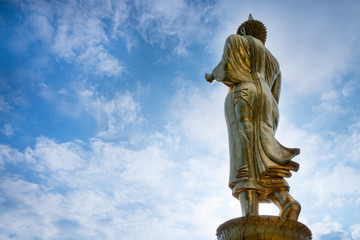 Fototapeta na wymiar Golden Buddha statue standing at Wat Phra That Khao Noi, Nan Province, Thailand