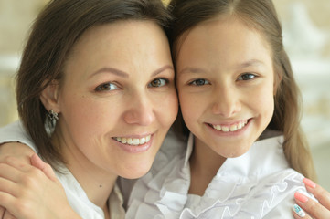 Portrait of beautiful woman and girl at home